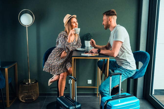 The seating area in Lublin Airport's Business Executive Lounge features a table with chairs, accommodating travelers with luggage.