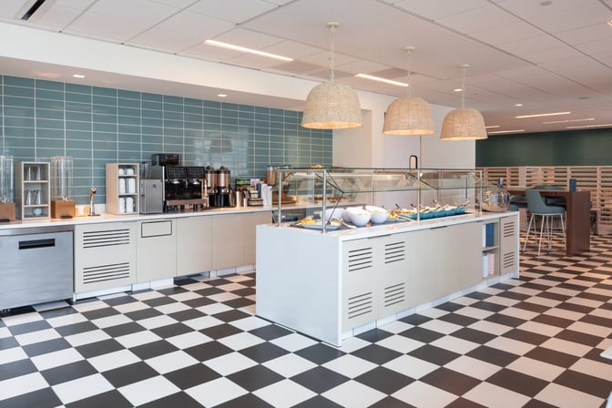 The Escape Lounge at Luis Munoz Marín International Airport features a self-serve food area with coffee machines and breakfast options.