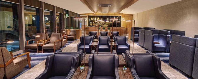The seating area at Plaza Premium Lounge in Mactan-Cebu International Airport features individual chairs and semi-private booths with tables.
