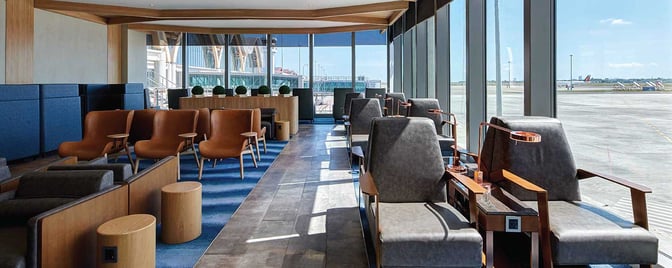 The seating area in Plaza Premium Lounge at Mactan-Cebu International Airport offers comfortable chairs with tarmac views through large windows.