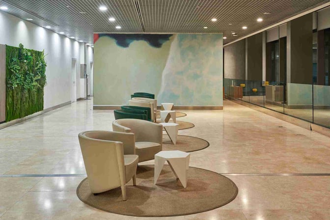 Seating area in Sala VIP T3 at Malaga Airport features arranged armchairs and small tables, providing a comfortable waiting space.