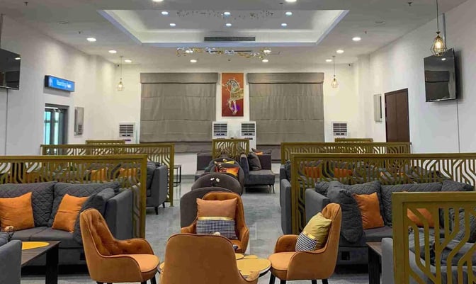 Seating area in Lounge One at Mallam Aminu Kano International Airport features cushioned chairs and sofas with partitioned sections for privacy.