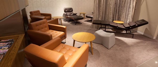 The seating area in Manchester Airport's Escape Lounge features comfortable armchairs and recliners with small tables for relaxation.