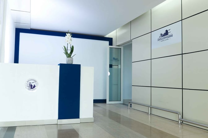 The entrance to the Executivo 2000 Lounge at Maputo International Airport features a reception desk and a glass door.