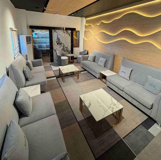 The seating area at Bomgarfo Lounge, Maputo International Airport, features comfortable sofas and marble-topped tables for passenger relaxation.