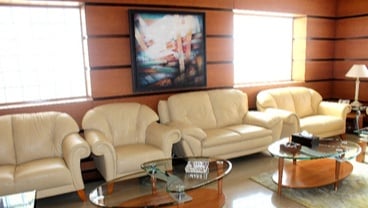 The seating area in the Pearl Lounge at Marsa Alam International Airport features comfortable sofas and glass coffee tables for relaxation.