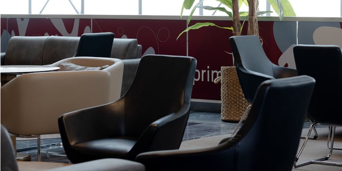 Seating area at Primeclass Lounge, Milas–Bodrum Airport, features comfortable chairs and tables for relaxation and socializing.