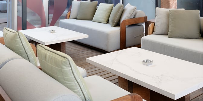 The seating area at Primeclass Lounge, Milas–Bodrum Airport, features cushioned sofas and marble tables for passenger comfort and relaxation.