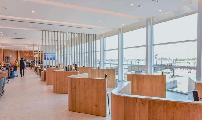 The BBVA Lounge at Ministro Pistarini International Airport features semi-private seating areas with views of the airport tarmac.