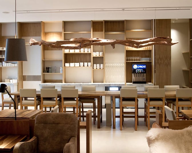 The Star Alliance Lounge in Buenos Aires features a modern design with wooden accents, a sleek ba...
