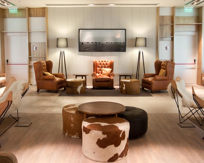 The Star Alliance Lounge in Buenos Aires features stylish leather armchairs, cowhide poufs, and a...