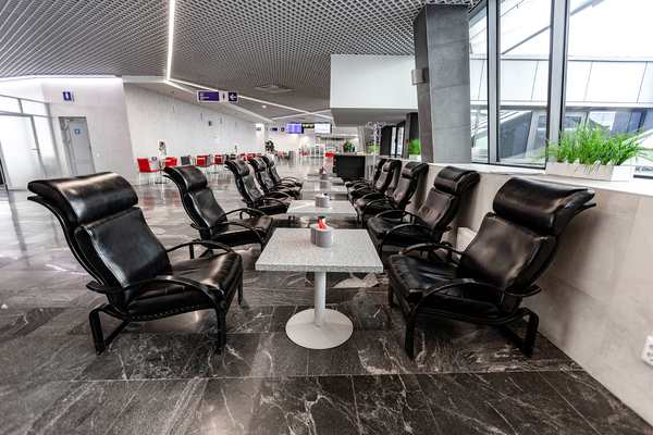 The seating area in the Domestic Business Lounge at Minsk National Airport features comfortable chairs and small tables for travelers.
