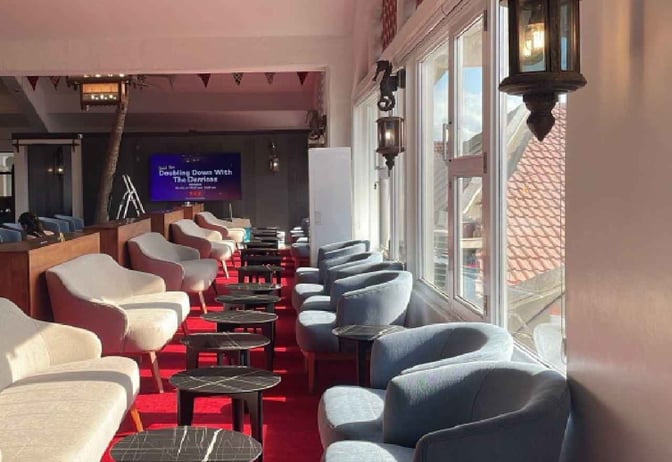 Seating area in the Bosphorus Lounge at Moi International Airport features armchairs and small tables with views through large windows.