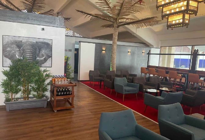 The Bosphorus Lounge at Moi International Airport features a seating area with armchairs and a beverage cart offering drinks.