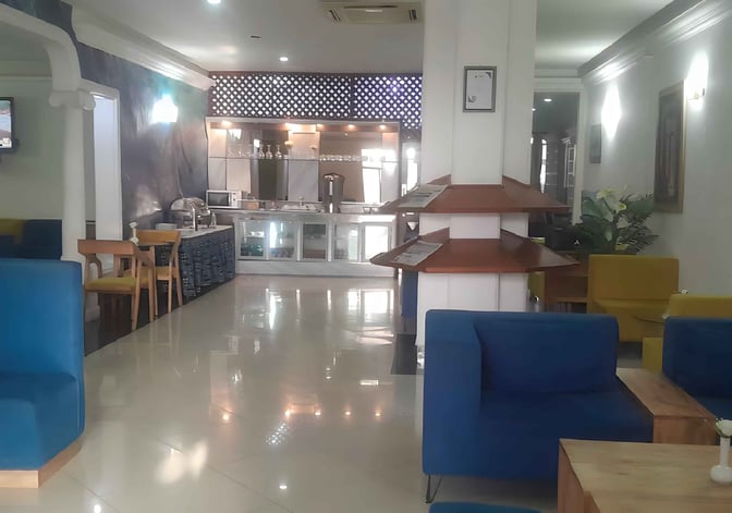 The Safari Comfort Lounge at Moi International Airport features a seating area with armchairs and a self-serve food station.