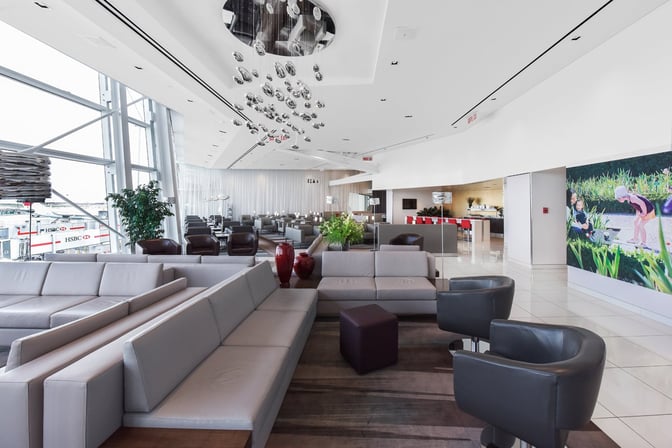 The National Bank Lounge at Montreal-Trudeau International Airport features spacious seating areas with views of the tarmac and a self-serve food station.