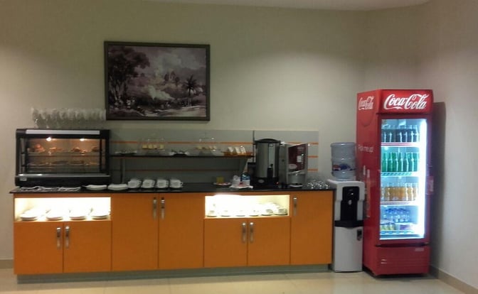 The CIP Lounge at Multan International Airport features a self-serve beverage area with a hot drink station and refrigerated soft drinks.