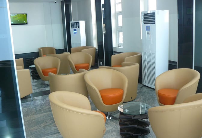 The Gabfol Lounge at Murtala Muhammed International Airport features comfortable seating with armchairs and small tables, ideal for relaxation.