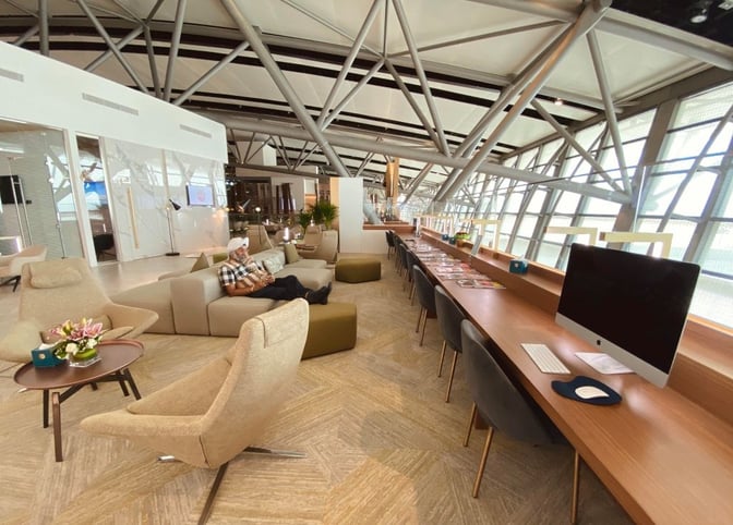 The Majan Lounge at Muscat International Airport features a seating area with comfortable chairs and a work station equipped with computers.