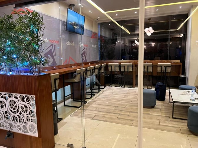 The Le Meilleur VIP Lounge at N'Djili International Airport features a bar area with high stools and a seating area with tables.
