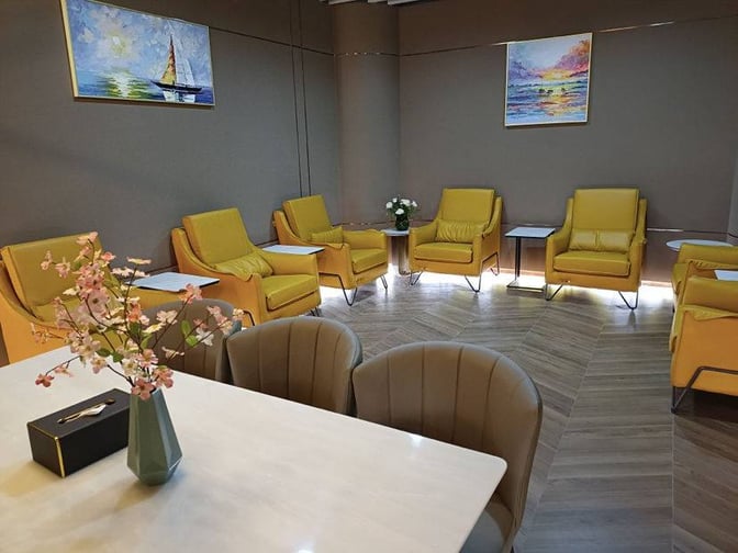 The seating area in China Southern Airlines Lounge at Nanjing Lukou International Airport features armchairs and tables for passenger comfort.