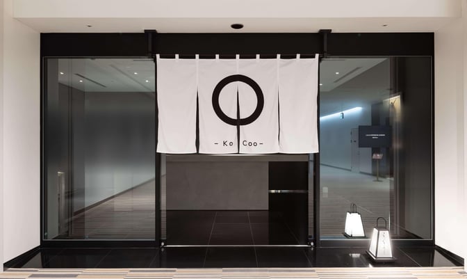 The entrance to the IASS Superior Lounge -KoCoo- at Narita International Airport features a traditional curtain and signage.