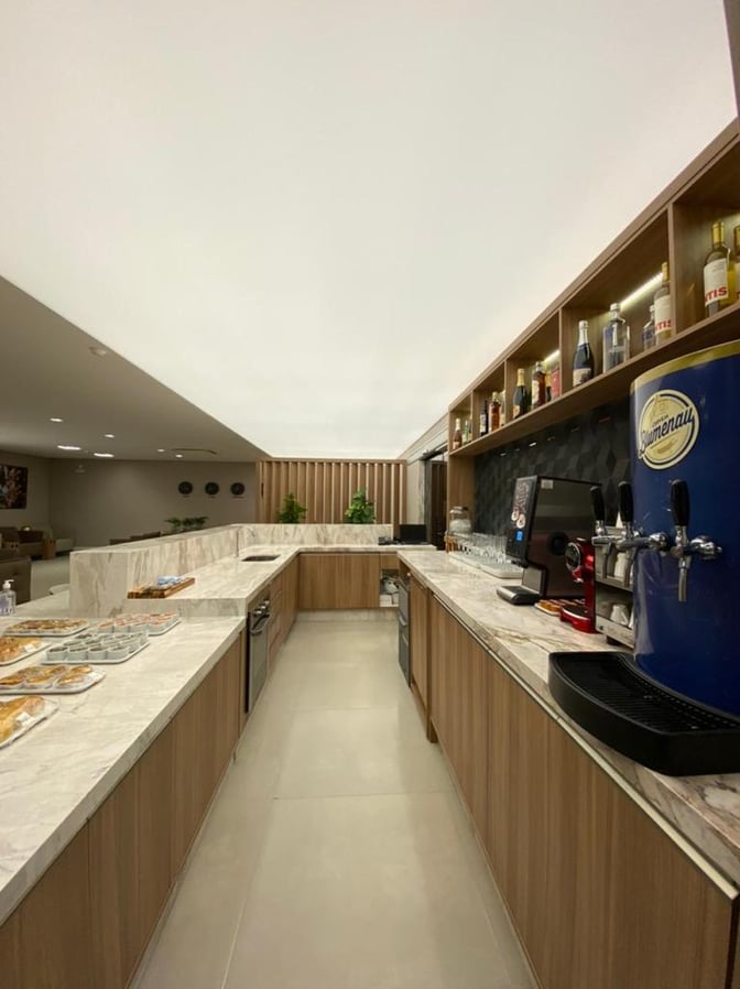 The W Lounge at Navegantes Airport features a self-serve food and beverage area with pastries, drinks, and coffee machines.