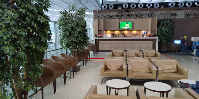 The Travel Club Lounge at Kolkata Airport features a bar with a variety of beverages and comfortable seating areas.