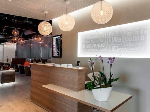 The reception area of the Levity Lounge at Nice International Airport features a welcome desk with seating visible in the background.