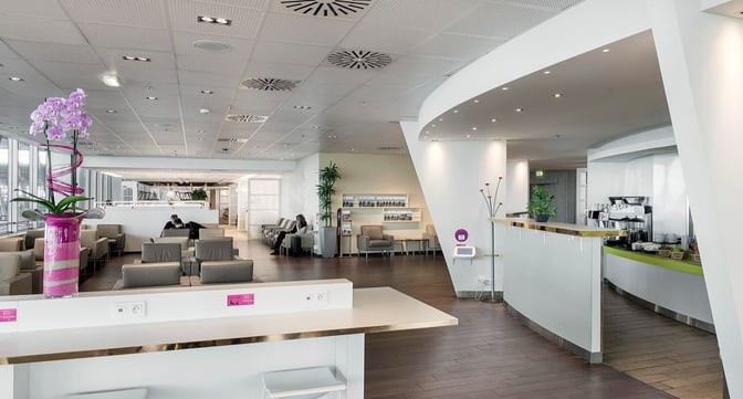 The Infinity Lounge at Nice International Airport features a seating area with armchairs and a self-serve coffee station.