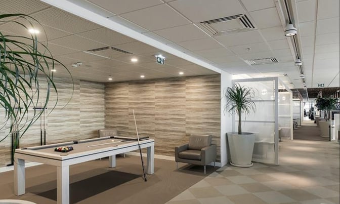 The Infinity Lounge at Nice International Airport features a billiards table and seating area for relaxation and entertainment.