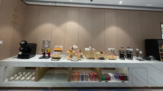 The self-serve snack station in Airlines Lounge 2 at Ningbo Lishe International Airport offers beverages, snacks, and instant noodles.