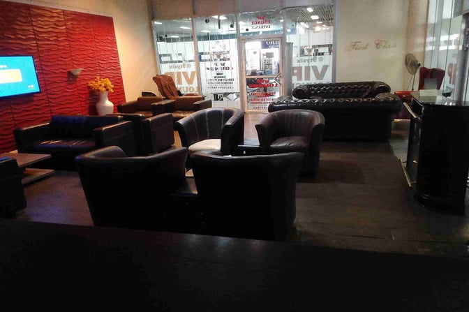 The @9TYSIX VIP Lounge at Nnamdi Azikiwe International Airport features comfortable seating areas with armchairs and sofas for relaxation.