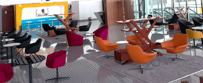 The seating area in Pearl Lounge at Nnamdi Azikiwe International Airport features various chairs and tables for passenger relaxation.