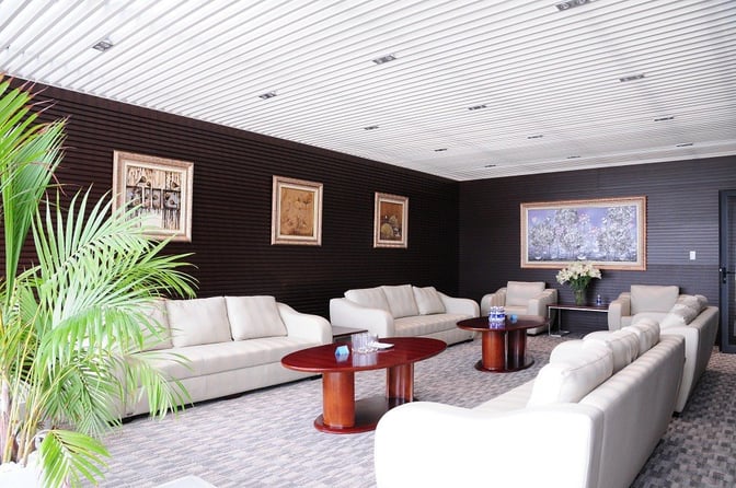 The ACV Business Lounge at Noi Bai International Airport features comfortable seating with sofas and coffee tables, complemented by framed artwork.