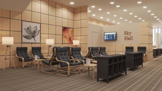 Seating area in Sky Hall at Nursultan Nazarbayev International Airport features cushioned chairs, small tables, and a flight information display.