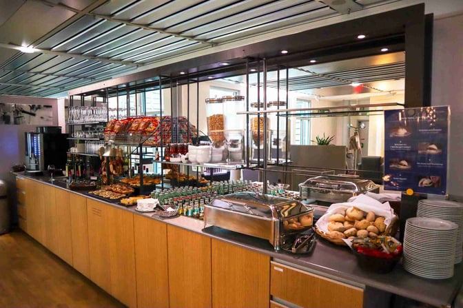 The Durer Lounge at Nuremberg Airport features a self-serve food area with a variety of snacks, beverages, and breakfast items.