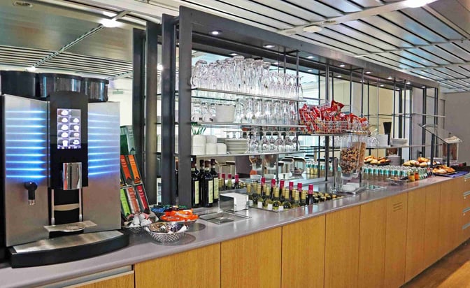 The Durer Lounge at Nuremberg Airport features a self-serve beverage and snack station with coffee, wine, and packaged snacks.