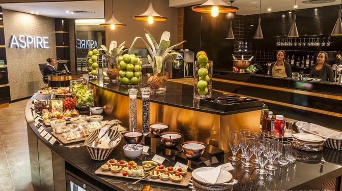 Self-serve food stations at the Aspire Lounge in O. R. Tambo International Airport offer a variety of snacks and beverages.