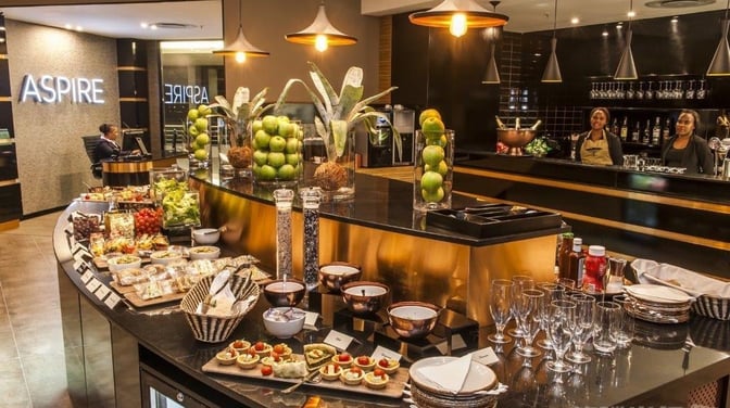 Self-serve food stations at the Aspire Lounge in O. R. Tambo International Airport offer a variety of snacks and beverages.
