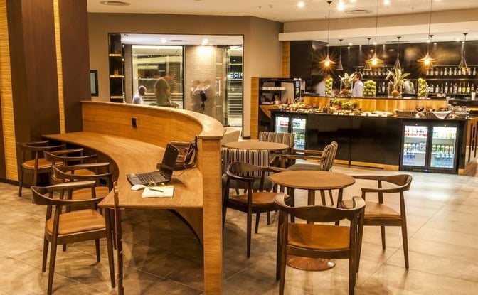 The Aspire Lounge at O. R. Tambo International Airport features a bar with a variety of beverages and seating for travelers.