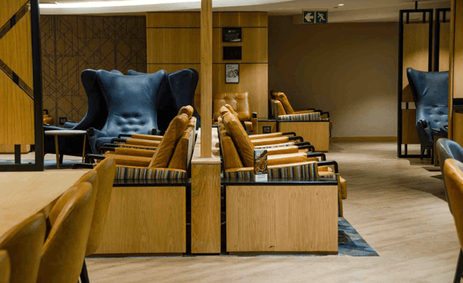 The seating area in Bidvest Premier Lounge at O. R. Tambo International Airport features comfortable chairs and semi-private spaces for relaxation.
