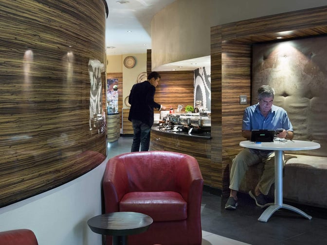 The Shongololo Lounge at O. R. Tambo International Airport features a seating area and a self-serve buffet with hot food options.