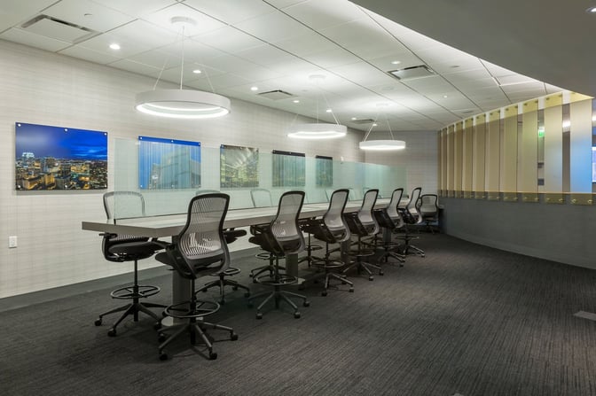 The Club MCO Airside 4 features a business area with high-top tables and ergonomic chairs for travelers to work comfortably.