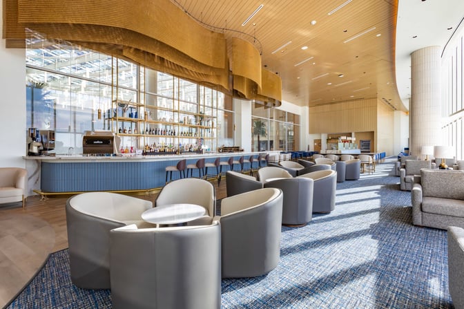 The Plaza Premium Lounge at Orlando International Airport features a bar with a variety of beverages and comfortable seating areas.
