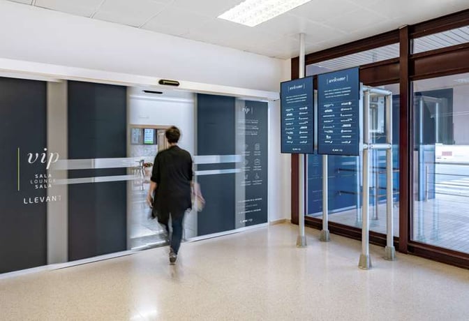 The entrance to Sala VIP Llevant at Palma de Mallorca Airport features sliding doors and informational signage nearby.