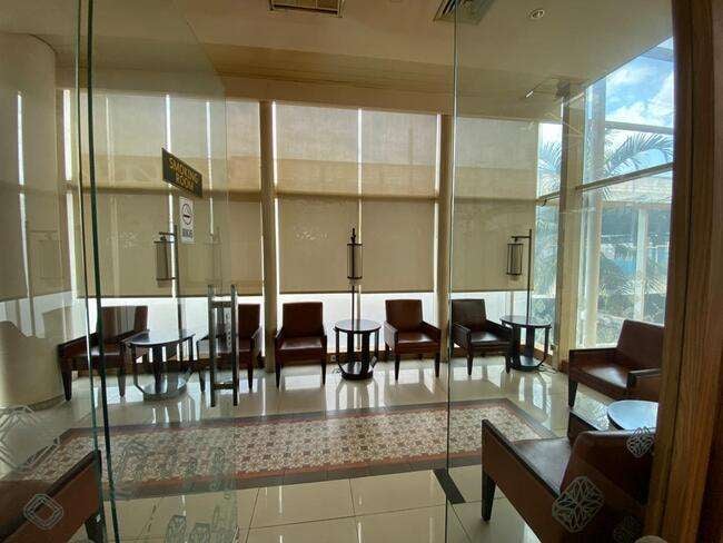 The seating area in Saphire Lounge at Depati Amir Airport features comfortable chairs and tables with window views.