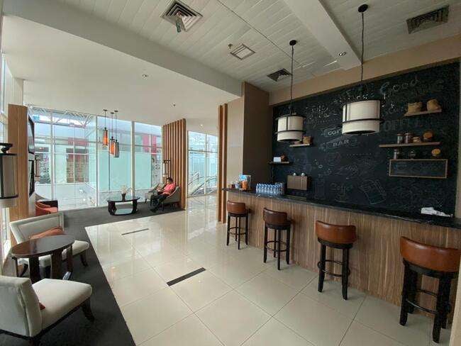 The Saphire Lounge at Depati Amir Airport features a bar area with counter seating and a seating area with tables and chairs.