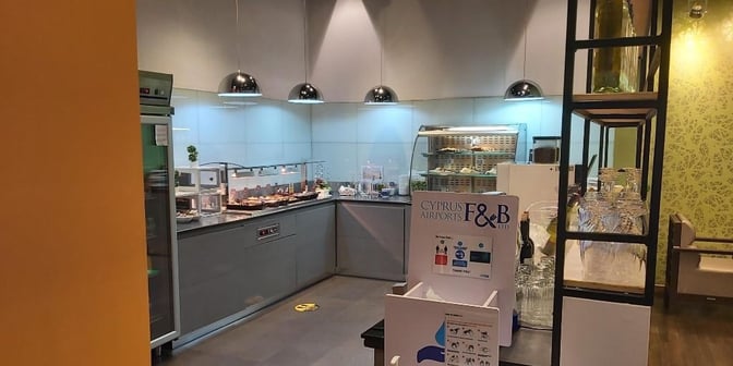 The food area in the Premium Lounge at Paphos International Airport features self-serve stations with snacks and beverages.
