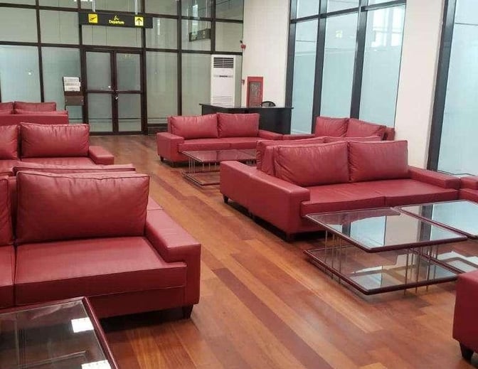 The seating area in the CIP Lounge at Peshawar Bacha Khan International Airport features multiple sofas and glass coffee tables.